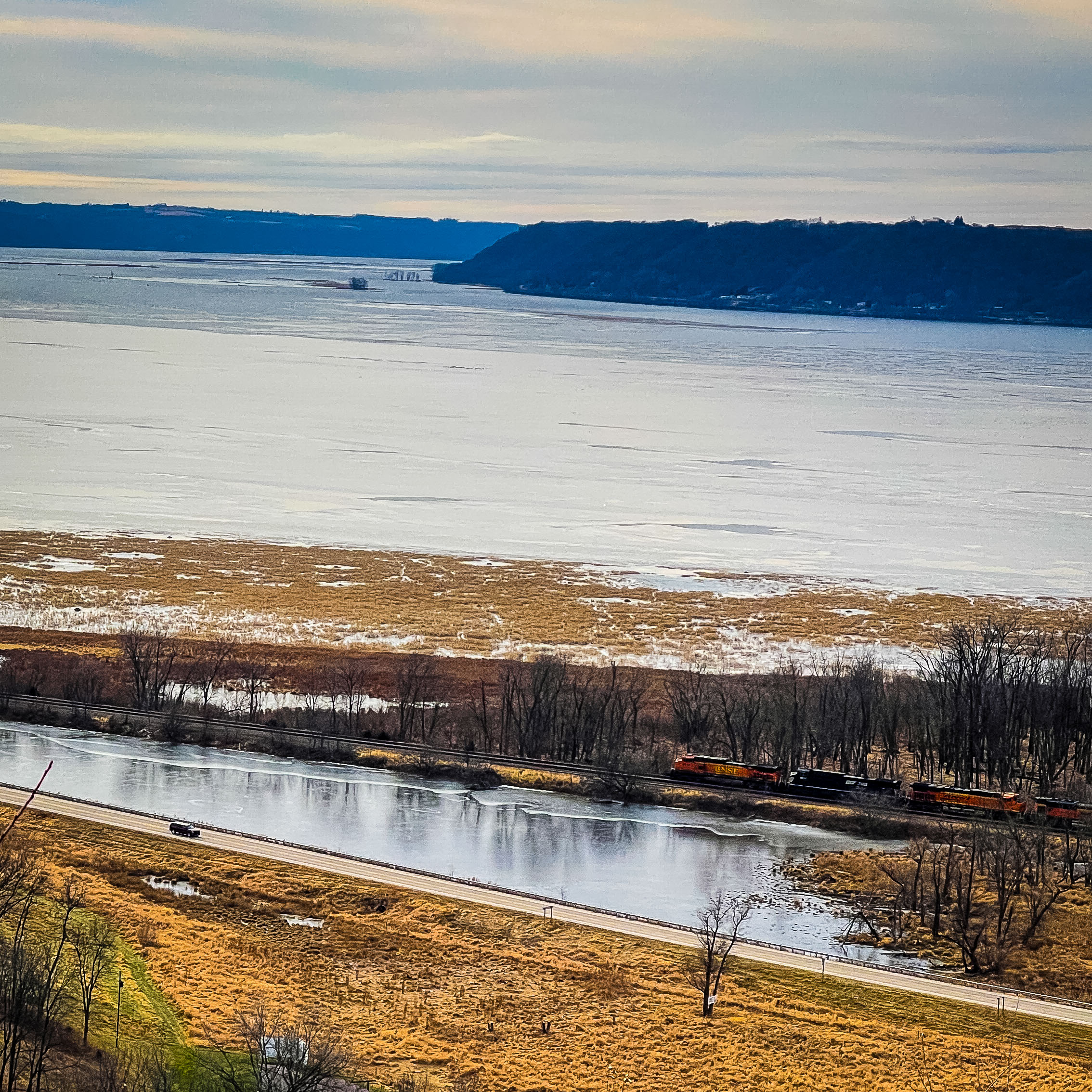 A train passes below Sugar Creek Bluff Overlook near the Mississippi River